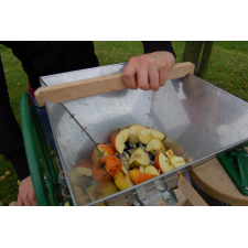 Person using a scratter to crush apples.