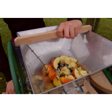 Apples being crushed by a fruit crusher.