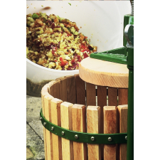 Apples pouring into basket of fruit press.