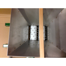 Top down view of fruit scratter hopper with wooden hand grip.