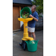 Man pouring apples into Speidel mill from green tub.