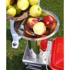 Apples being poured into the spout of the Fruit Shark mill.