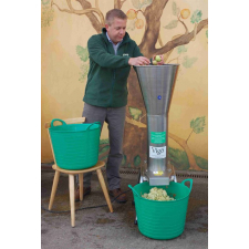 Man using stainless steel mill to crush apples.