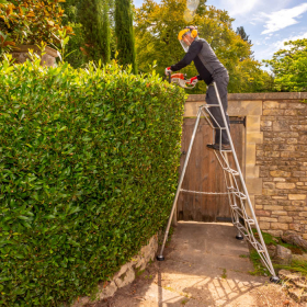 8ft Henchman Tripod ladder being used for hedge trimming